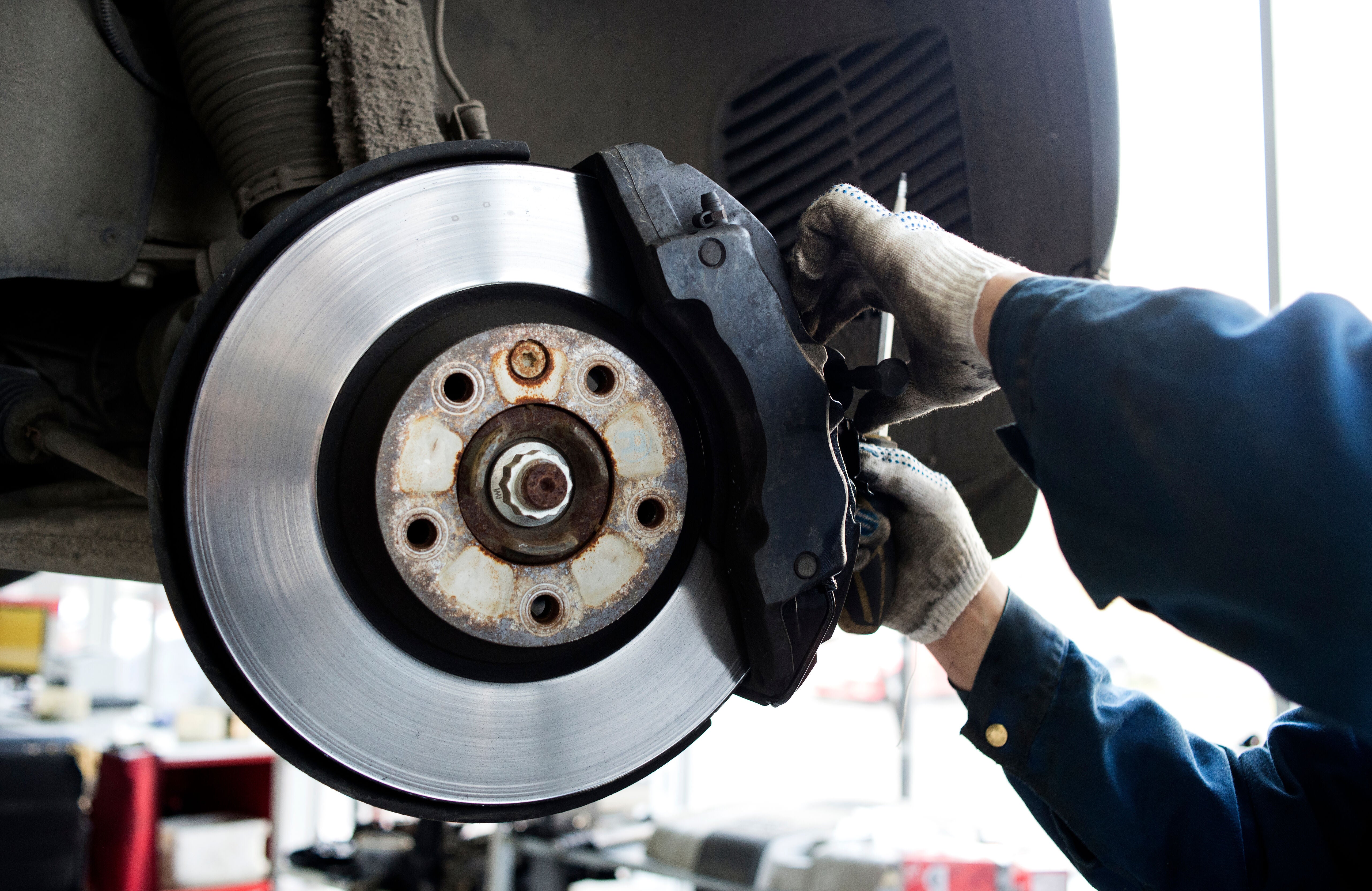 Brake rotor and caliper inspection during vehicle brake service.